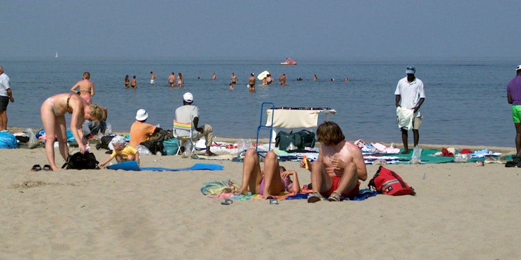 Sunbathing on the wide sandy beach in Lido di Spina, Emilia Romagna